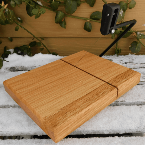 Cherry Wood cheese slicing board with clear rubber grip feet.
