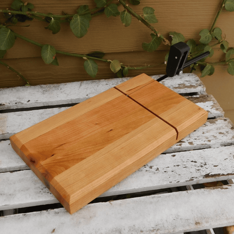 Butcher block cherry wood cheese slicing board, finished in a food grade oil and beeswax mixture to give it a beautiful sheen.