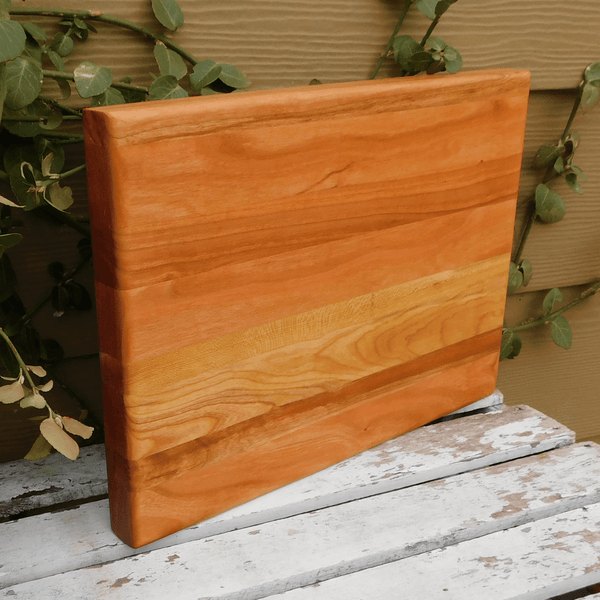 Cherry Wood edge grain cutting board finished in a food grade beeswax and mineral oil mixture to give it a beautiful sheen.