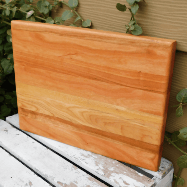 Cherry Wood edge grain cutting board finished in a food grade beeswax and mineral oil mixture to give it a beautiful sheen.