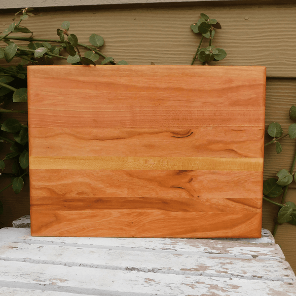 Cherry Wood edge grain cutting board finished in a food grade beeswax and mineral oil mixture to give it a beautiful sheen.