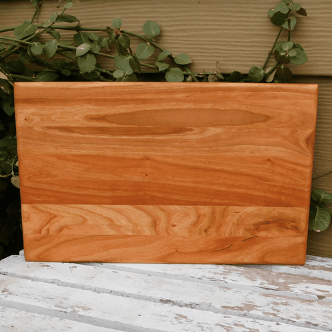 Cherry Wood edge grain cutting board finished in a food grade beeswax and mineral oil mixture to give it a beautiful sheen. Handcrafted in the USA by Springhill Millworks.