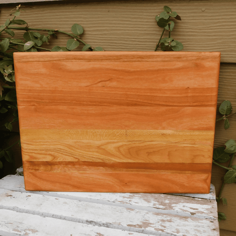 Cherry Wood edge grain cutting board finished in a food grade beeswax and mineral oil mixture to give it a beautiful sheen.