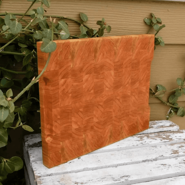 End grain cutting board with hand grooves on sides for easy handling. Finished in a food grade beeswax and mineral oil mixture.