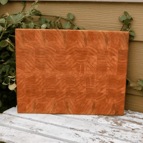 End grain cutting board with hand grooves on sides for easy handling. Finished in a food grade beeswax and mineral oil mixture.