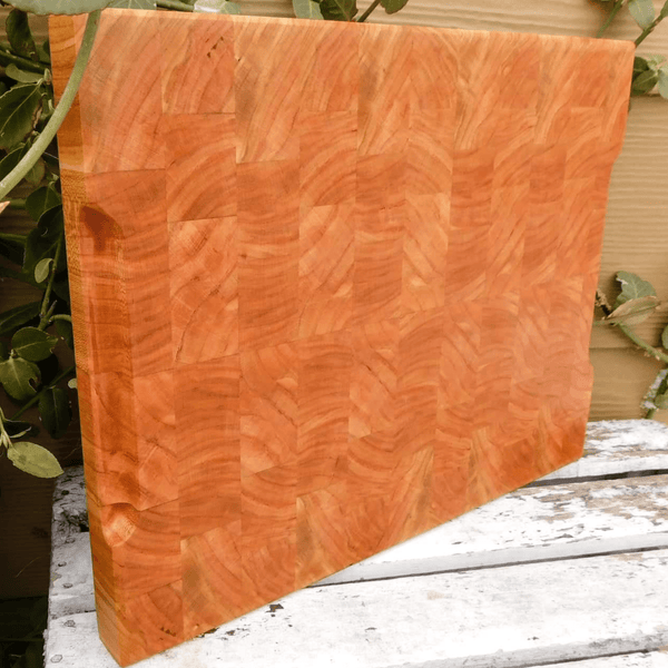 End grain cutting board with hand grooves on sides for easy handling. Finished in a food grade beeswax and mineral oil mixture.