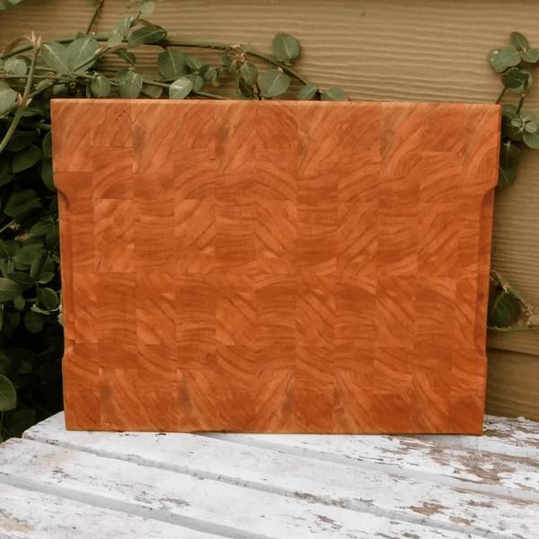 End grain cutting board with hand grooves on sides for easy handling. Finished in a food grade beeswax and mineral oil mixture.