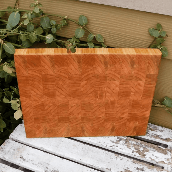 End grain cutting board with hand grooves on sides for easy handling. Finished in a food grade beeswax and mineral oil mixture.