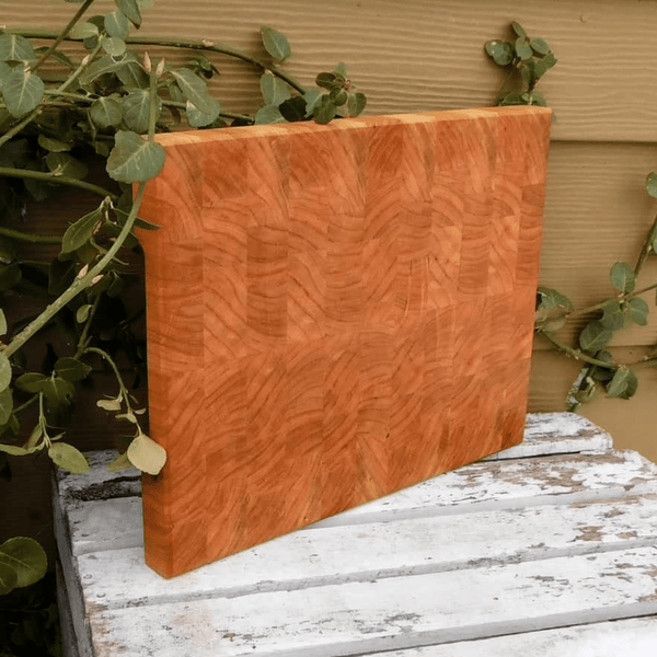 End grain cutting board with hand grooves on sides for easy handling. Finished in a food grade beeswax and mineral oil mixture.