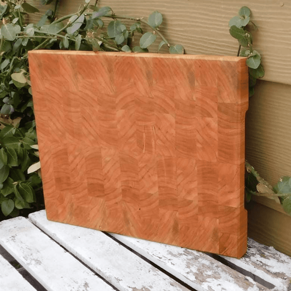 End grain cutting board with hand grooves on sides for easy handling. Finished in a food grade beeswax and mineral oil mixture.