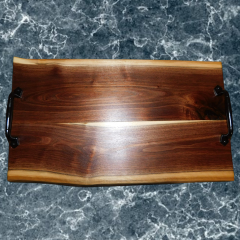 Large Black Walnut charcuterie board with cast iron handles & rubber grip feet. Handmade in the USA by Springhill Millworks.