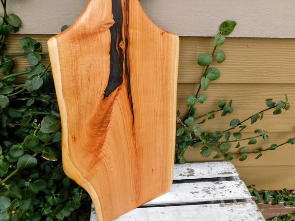 Long Cherry Wood charcuterie board with handle.