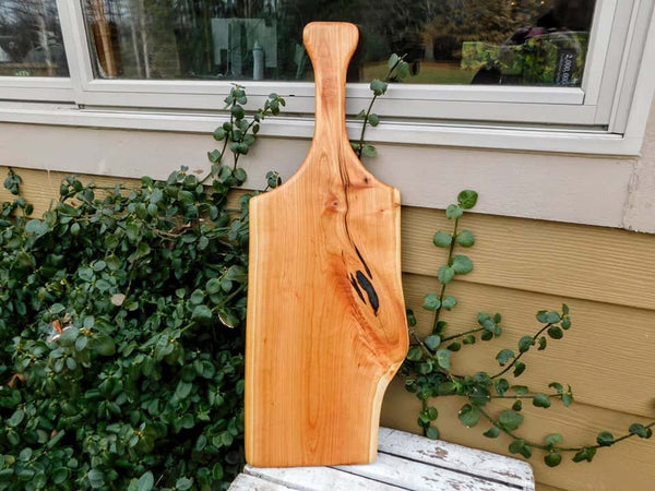 Long Cherry Wood charcuterie board with handle.
