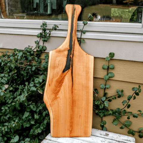 Long Cherry Wood charcuterie board with handle.