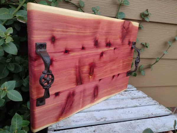 Large Red Cedar charcuterie board with heavy duty cast iron handles and clear rubber grip feet.