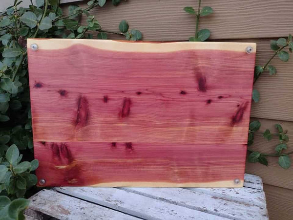 Large Red Cedar charcuterie board with heavy duty cast iron handles and clear rubber grip feet.