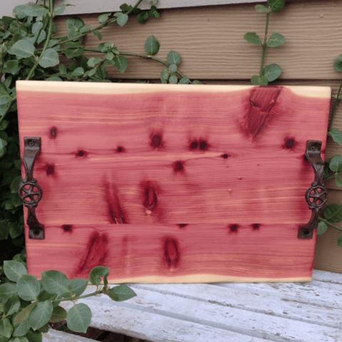 Large Red Cedar charcuterie board with heavy duty cast iron handles and clear rubber grip feet.